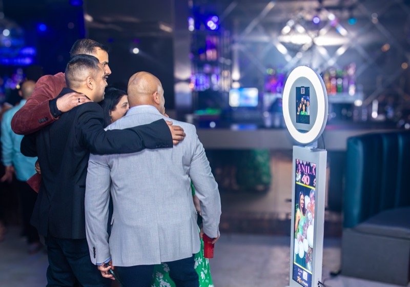 Guests using the All Stars selfie booth at a birthday party