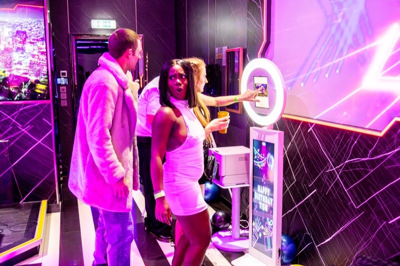 Guests posing at the All Stars selfie booth at a party event
